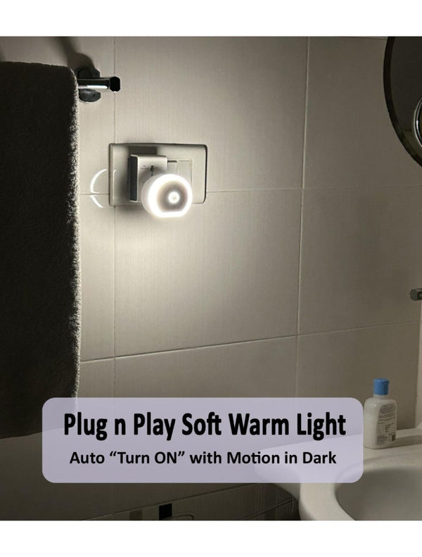 Motion sensor plug lamp night light automatically turning on in the dark when detecting movement.