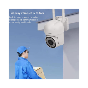 CCTV camera with a person in blue uniform and cap looking at it against a blue sky.