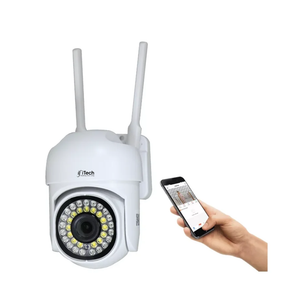 White security camera with antennas and a hand holding a smartphone displaying an app interface on a white background.