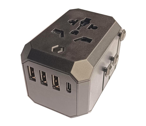 A close-up, angled view of the black IFITech Universal Travel Adapter. The front face shows the four charging ports: three USB-A ports and one USB-C port. The top surface features a multi-standard universal AC outlet, designed to accept various plug types. The sides have retractable pins for different international plug standards.
